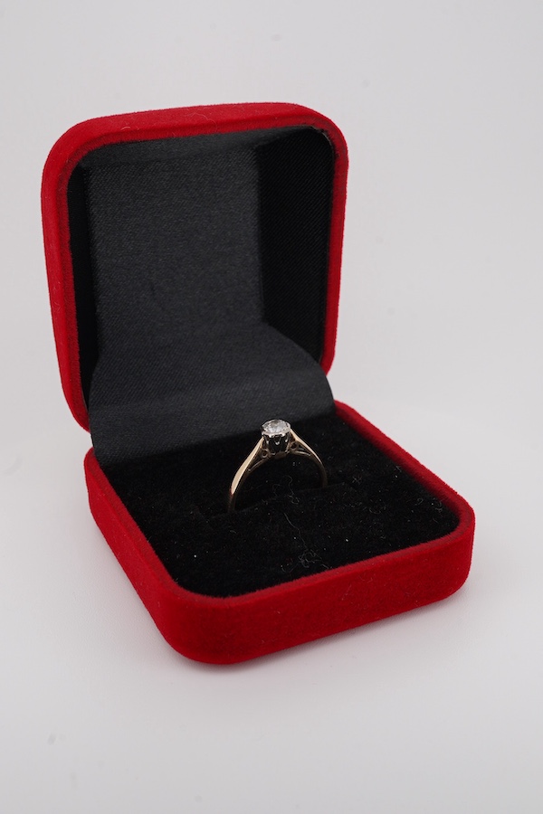 A solitaire diamond ring, collet-set with an antique circular-cut diamond weighing approximately 0.20 carats, mounted in 9ct gold, size L, British hallmarks, gross weight approximately 1.8 grams, Condition: fair